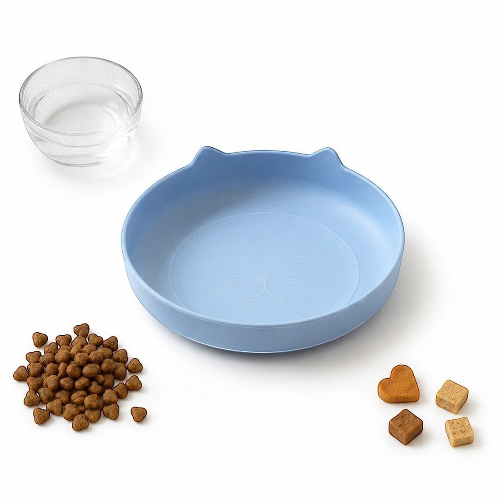 Tap2Own light blue cat-shaped pet food and water bowl with etched face detail. Shallow and wide design.