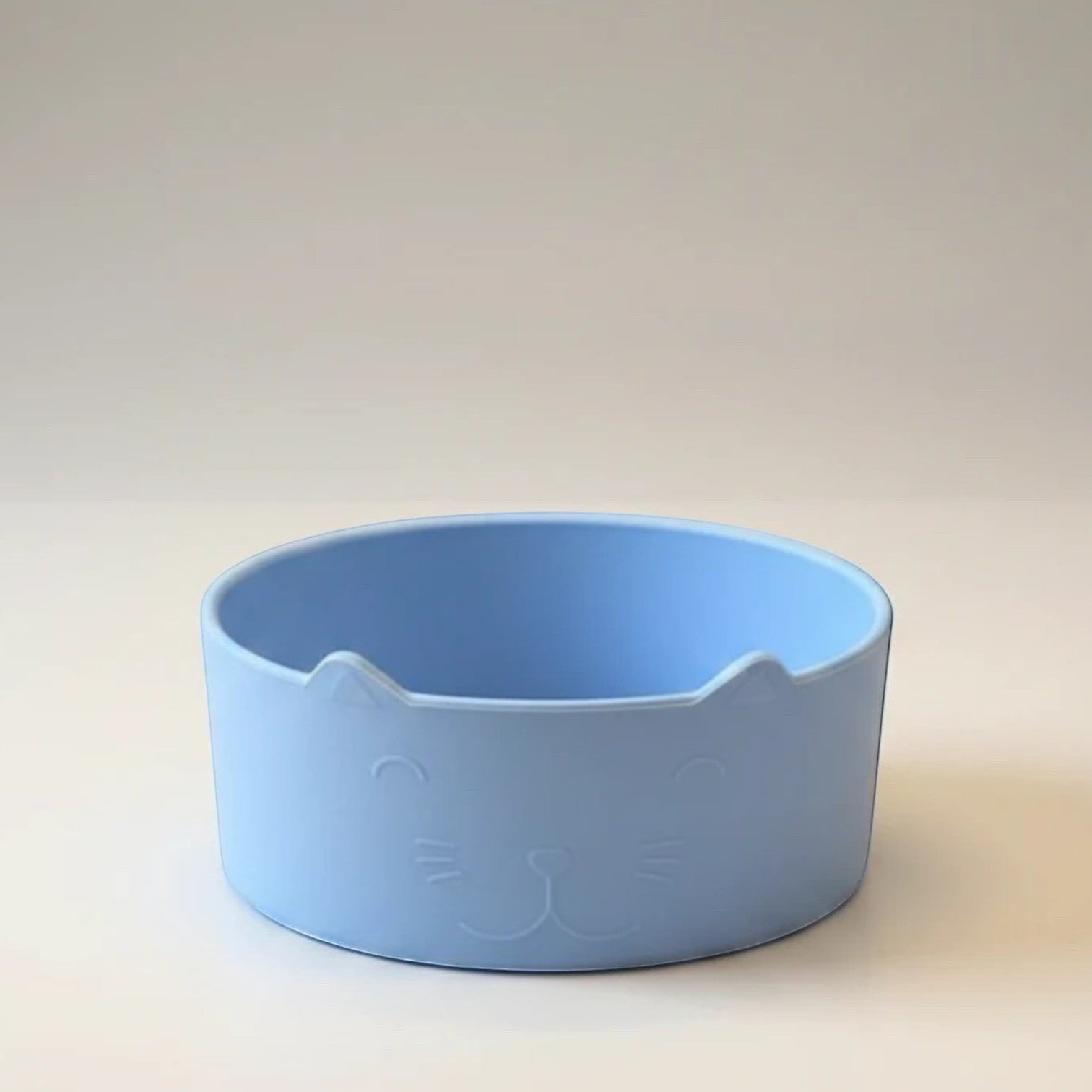 Tap2Own light blue cat-shaped pet food and water bowl with etched face and ears. Shallow and wide design.