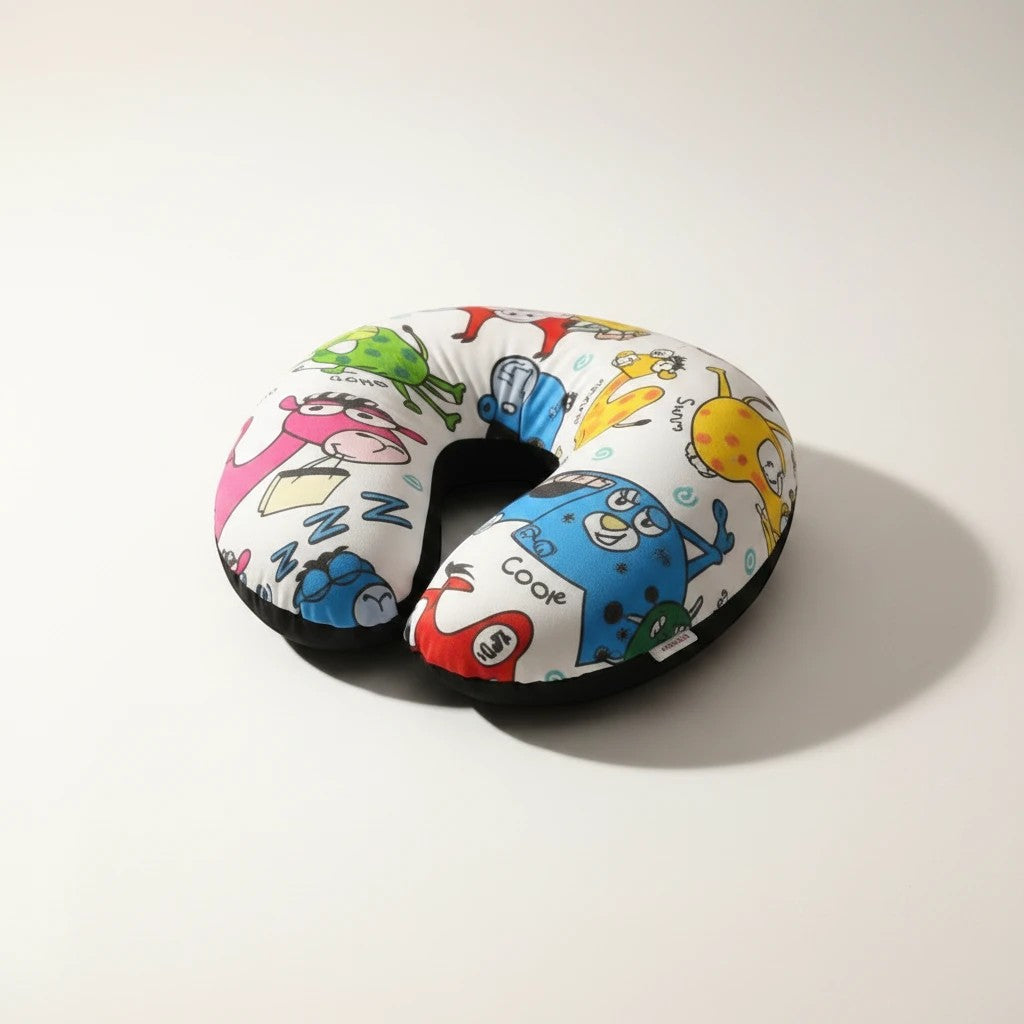 Tap2Own cartoon character travel neck pillow with colorful monsters and animals on white plush fabric.