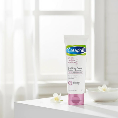 Tap2Own Cetaphil Bright Healthy Radiance creamy face cleanser in a white tube with a pink cap on a bright surface.