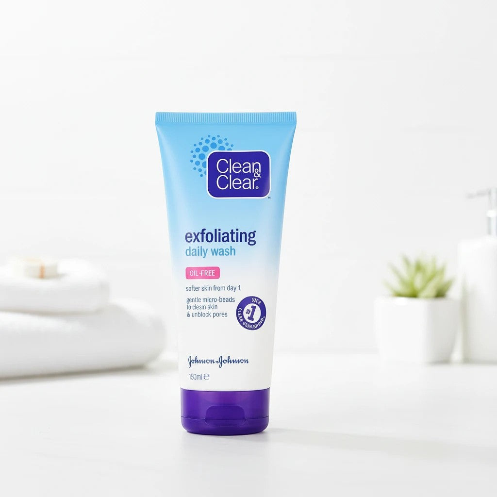 Tap2Own Clean & Clear Exfoliating Daily Wash in a light blue tube with a purple cap on a white bathroom counter.