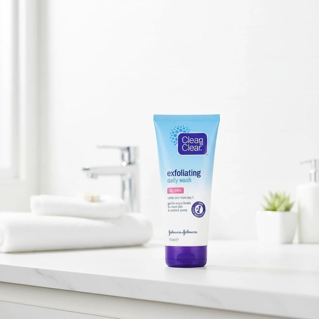 Tap2Own Clean & Clear exfoliating daily facial wash in a blue squeeze tube on a bathroom counter.