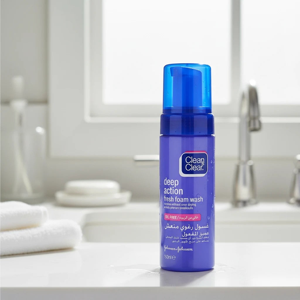Tap2Own Clean & Clear Deep Action Fresh Foam facial cleanser in a blue pump bottle on a bathroom counter.