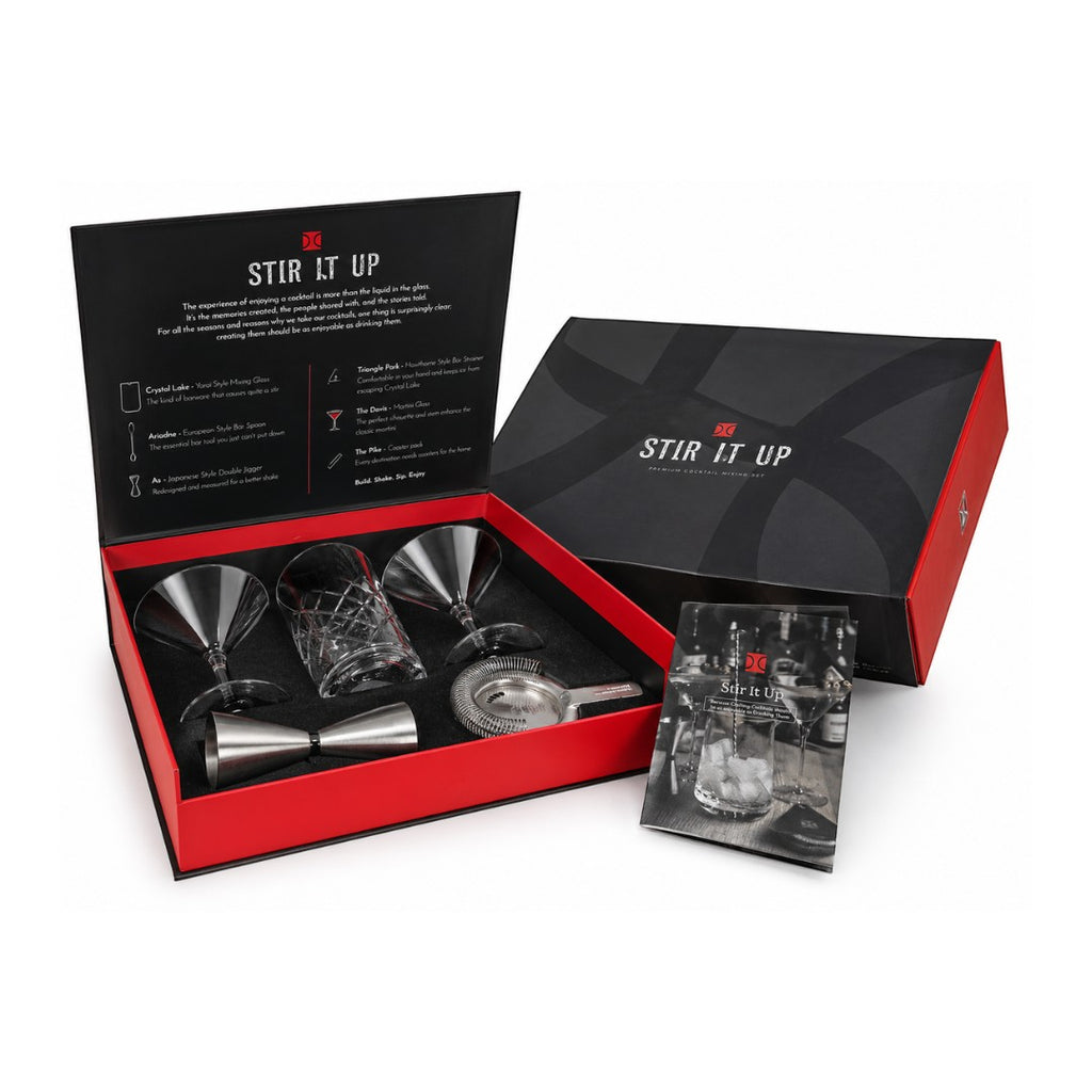 Tap2Own premium cocktail mixing set with crystal glasses, jigger, bar spoon, and strainer in a black and red box.