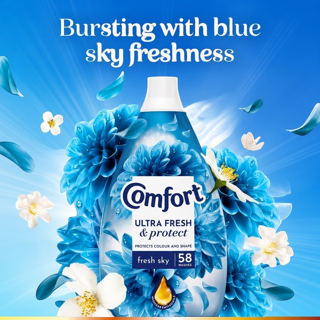 Tap2Own Comfort Ultra Fresh and Protect Fresh Sky fabric conditioner bottle surrounded by blue flowers and petals.