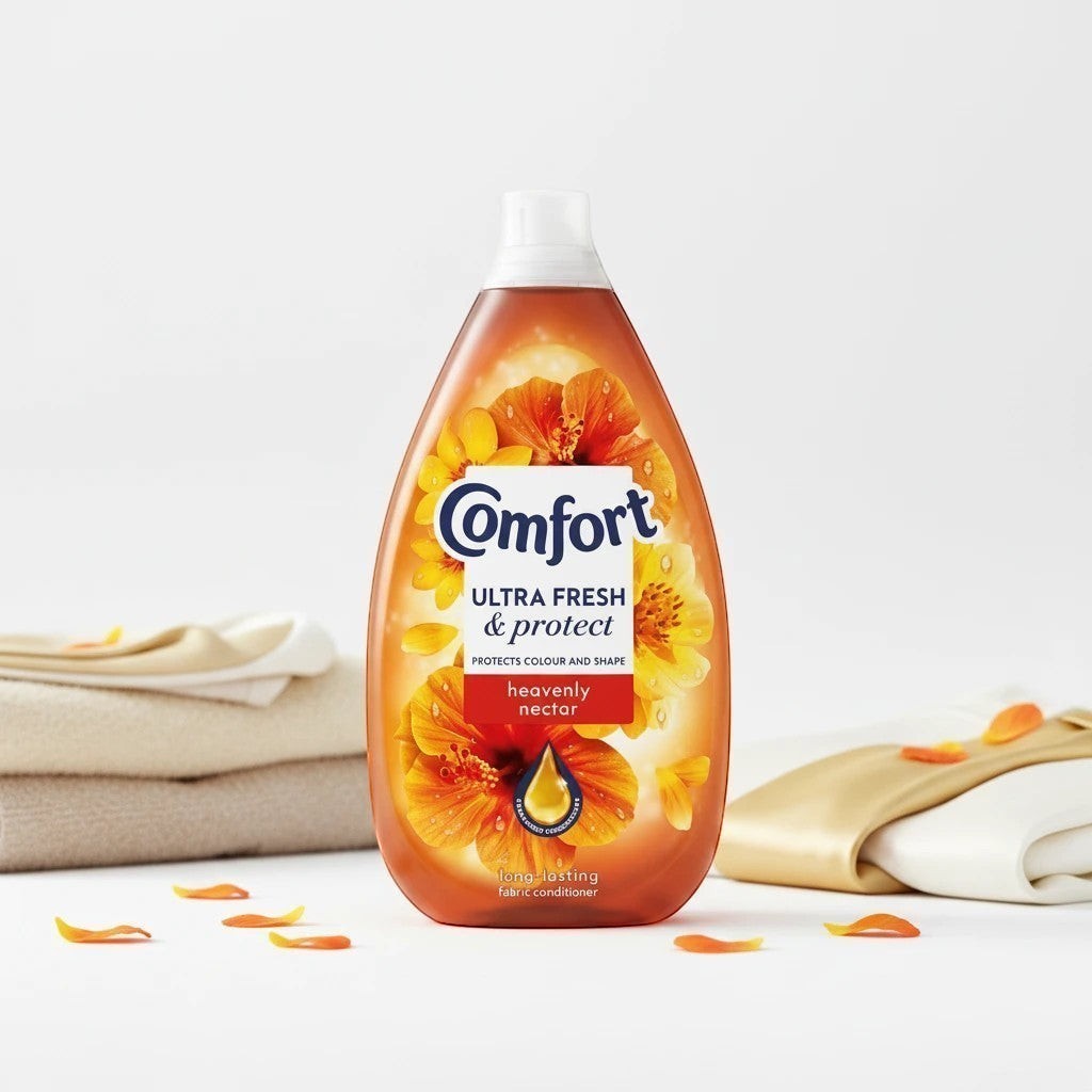 Tap2Own Comfort Ultra Fresh and Protect fabric conditioner bottle with orange floral design and folded laundry
