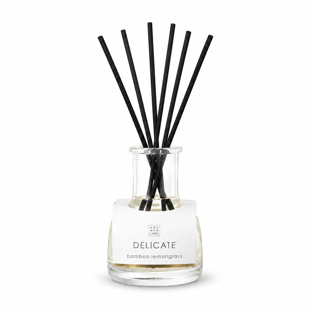 Tap2Own Delicate Bamboo Lemongrass perfume diffuser with black reeds in a clear glass bottle.
