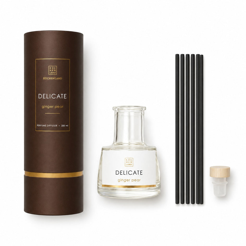 Tap2Own Delicate Perfume Diffuser in Ginger Pear scent, featuring a clear glass bottle, black reeds, and brown packaging.