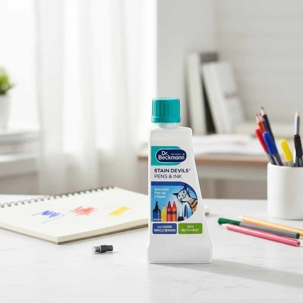Tap2Own Dr. Beckmann Stain Devils Pens and Ink remover bottle on a desk with art supplies for fabric stain removal
