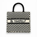 Tap2Own Be Yourself graphic tote bag in black and white geometric pattern with sturdy black handles.
