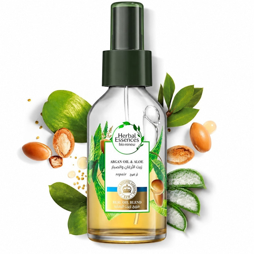 Tap2Own Herbal Essences bio:renew Argan Oil and Aloe hair oil spray bottle surrounded by argan nuts and aloe vera.