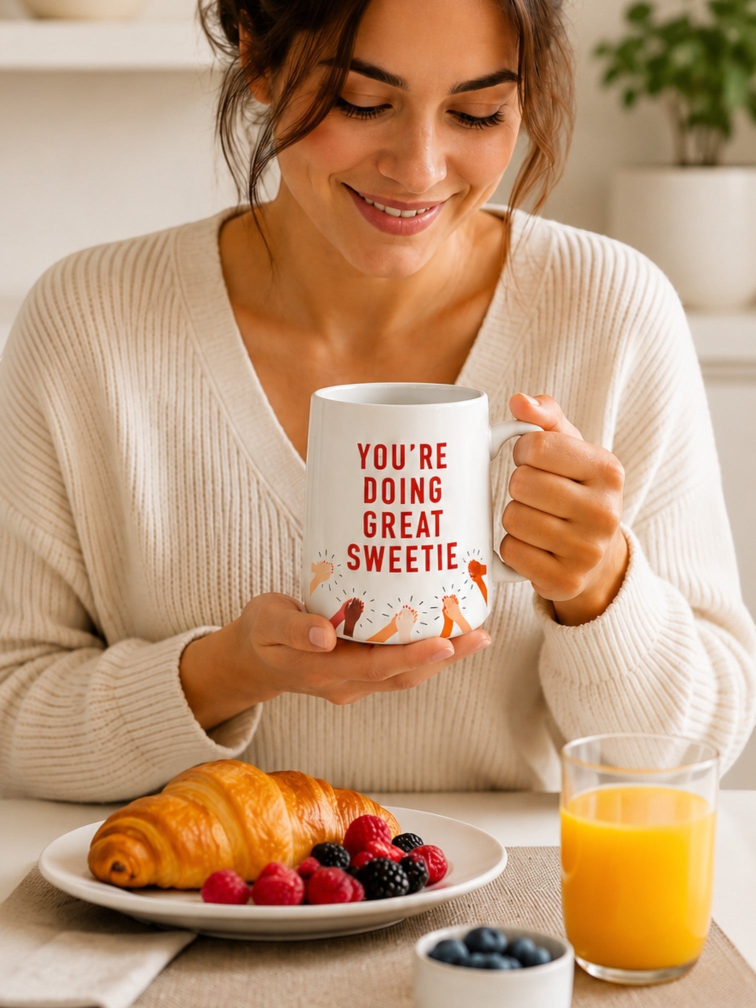 Woman holding a Tap2Own ceramic coffee mug with You're Doing Great Sweetie text and clapping hands illustration
