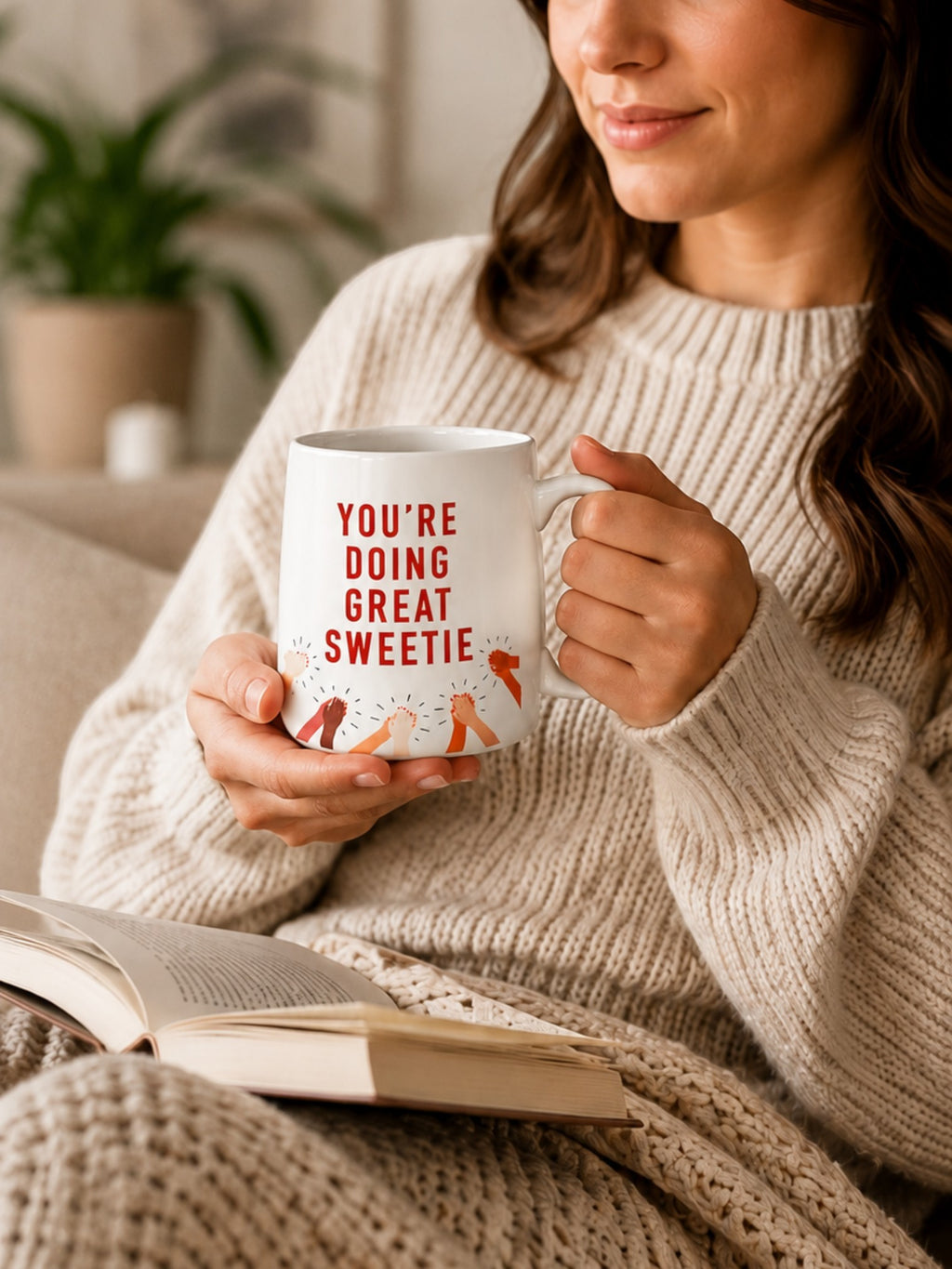 Woman holding a Tap2Own ceramic mug with You're Doing Great Sweetie text and clapping hands illustration