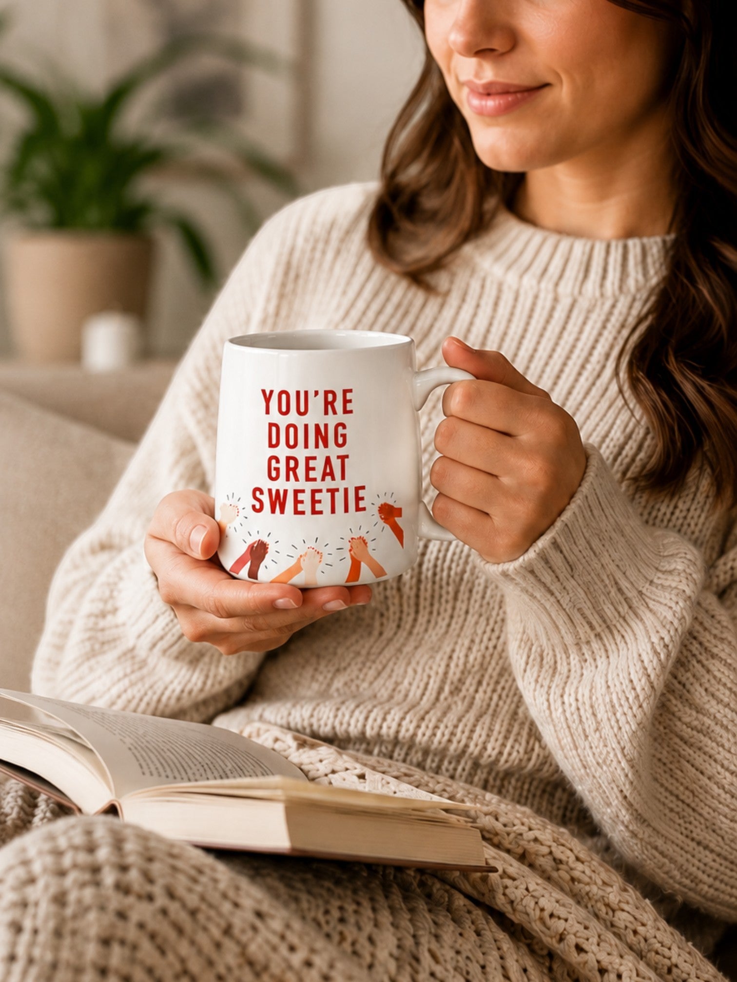 Woman holding a Tap2Own ceramic mug with You're Doing Great Sweetie text and clapping hands illustration