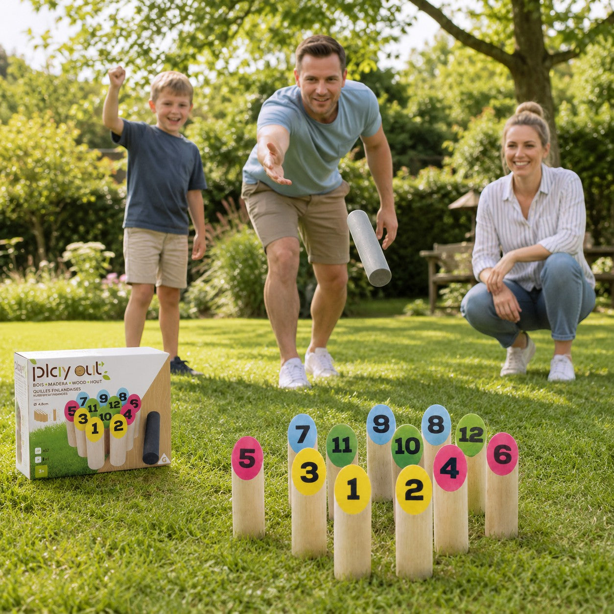 Tap2Own Playout wooden lawn bowling game set with numbered pins and throwing baton, played by a family in a backyard.