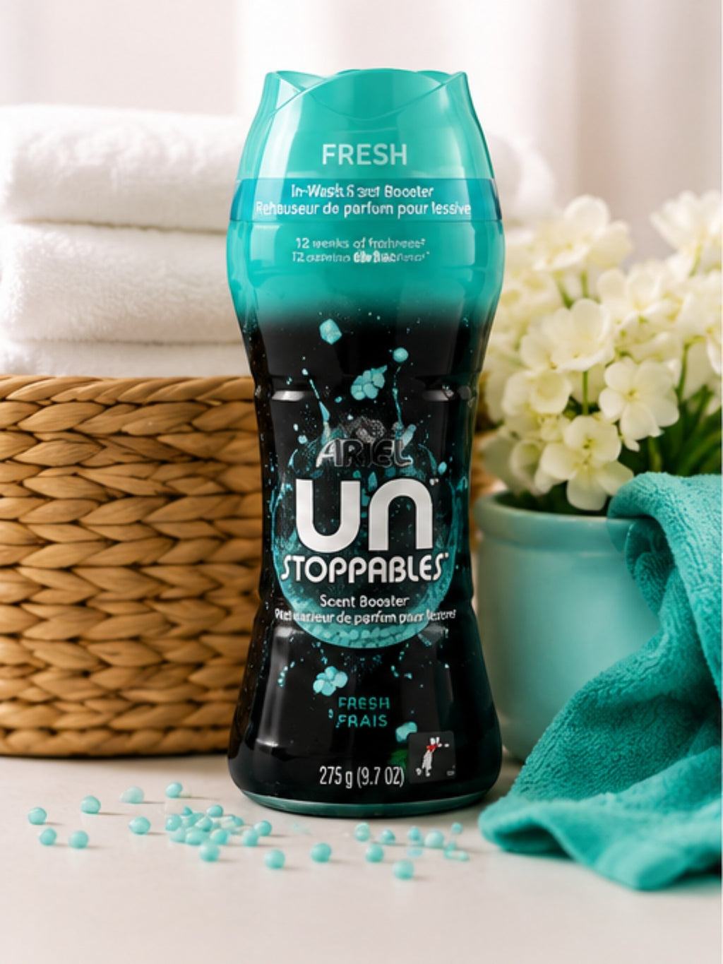 Tap2Own Lenor Unstoppables Fresh scent booster beads in a teal and black bottle on a white surface with towels.