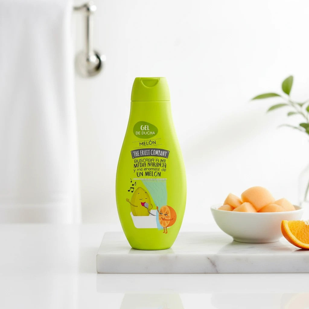 Tap2Own The Fruit Company melon scented shower gel in a green bottle with playful fruit graphics on a marble surface.