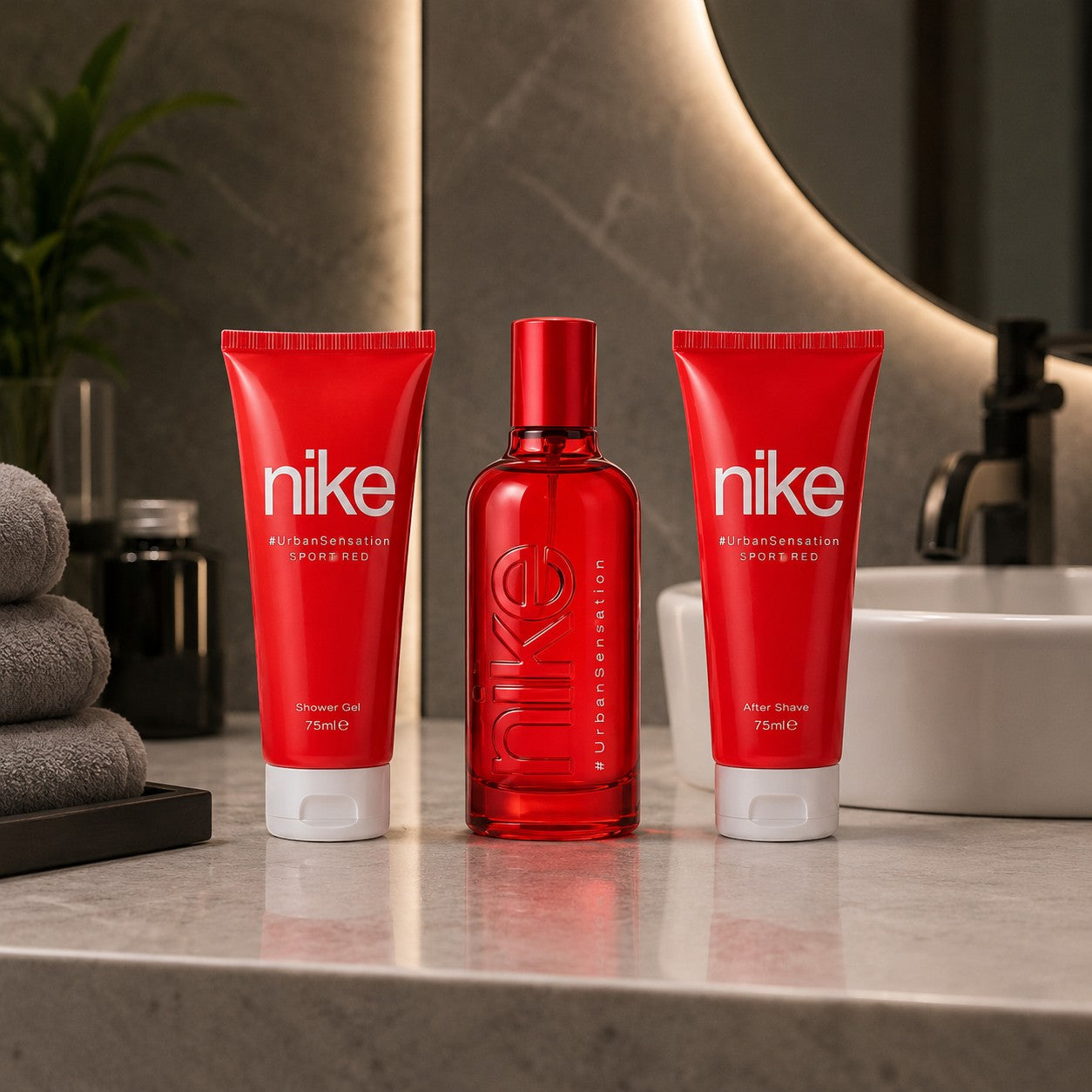 Tap2Own Nike CoralCrush fragrance gift set with red shower gel, body lotion, and perfume bottle on a bathroom counter.