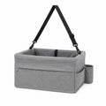 Tap2Own grey fabric pet booster seat with adjustable straps and side pockets for small to medium dogs.