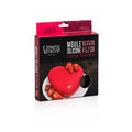 Tap2Own red silicone heart-shaped baking mold with strawberries on a white plate.