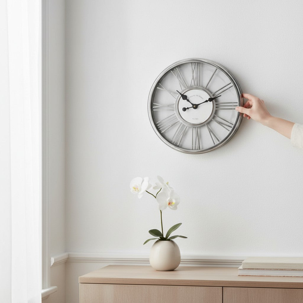 Tap2Own Classic Roman Numeral Wall Clock, silver-tone metal frame, white face with Roman numerals, open-worked design.