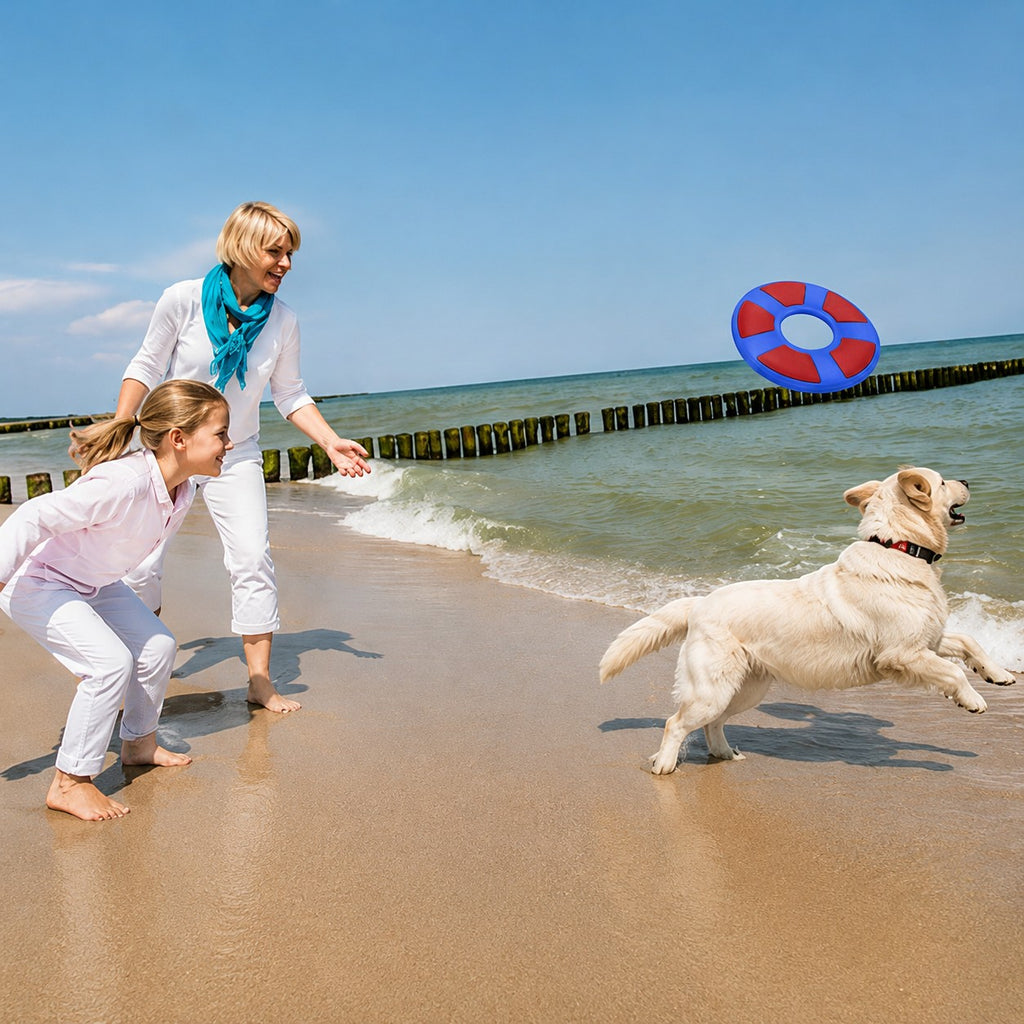 Tap2Own blue and red rubber flying ring dog toy in mid-air on a beach with a golden retriever jumping to catch it.