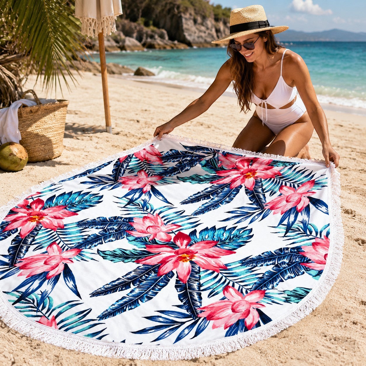 Tap2Own round beach towel with tropical floral print, pink hibiscus flowers, green palm leaves, and fringe trim.